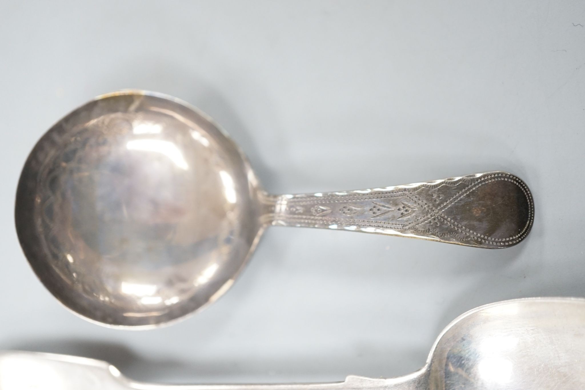 A set of six early Victorian silver fiddle pattern teaspoons, Charles Boyton, London, 1844 and a George IV silver caddy spoon, Birmingham, 1821, 3.5oz.